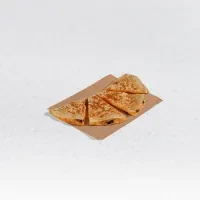 Four golden-brown quesadilla triangles with dark filling on a tray.