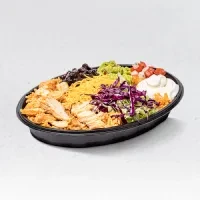 Overhead colorful chicken burrito bowl with distinct ingredient sections.