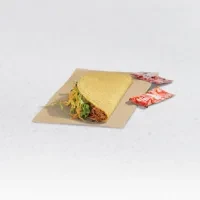 Hybrid taco with meat, lettuce, and two sauce packets on parchment.