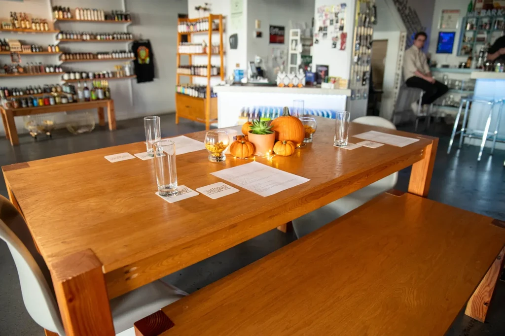 Fall-decorated table with amber liquid glasses at a cozy tasting room.
