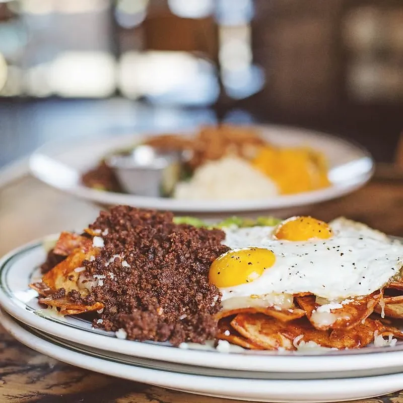 Chilaquiles plate with chorizo, fried eggs and queso fresco
