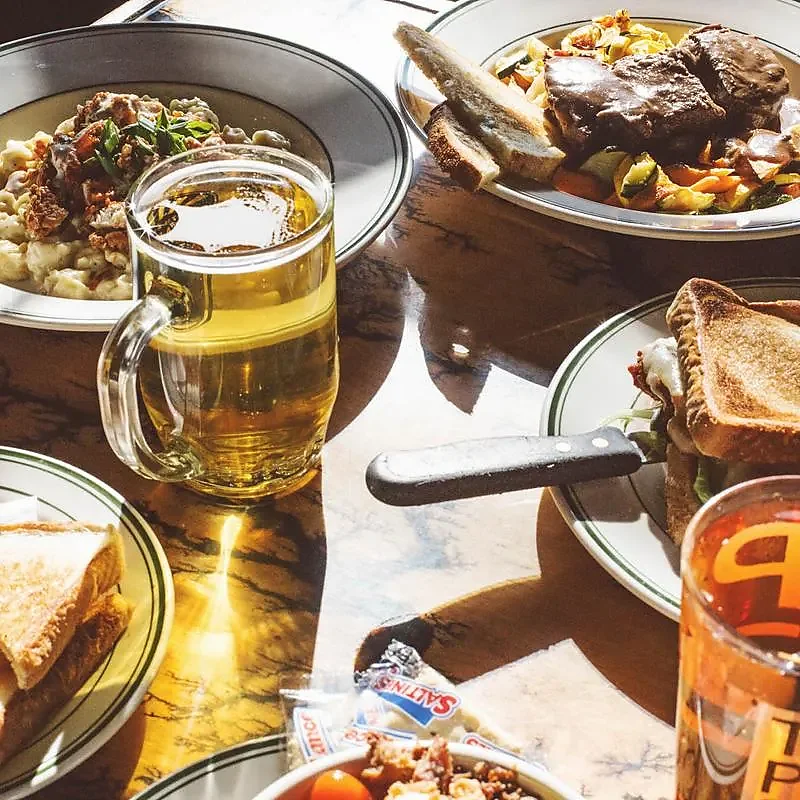 Table spread of sandwiches, mac and cheese with beer mug