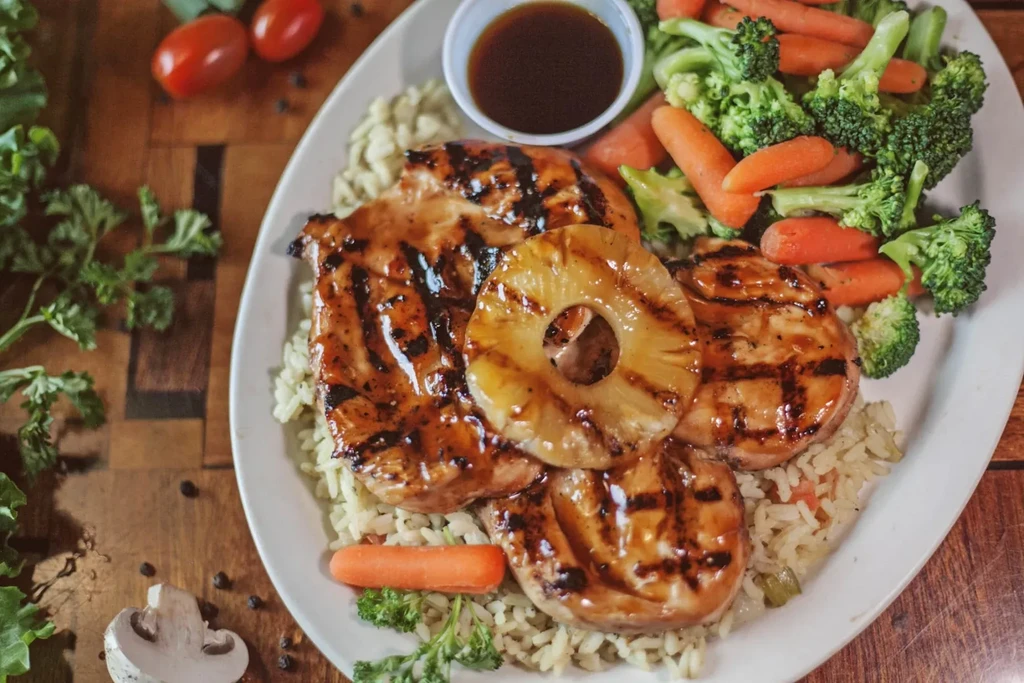 Grilled chicken and pineapple with rice and steamed vegetables.