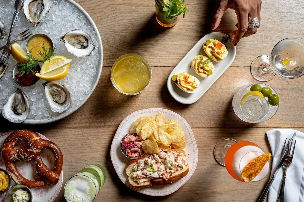 An overhead view of a table laden with various appetizers and drinks.