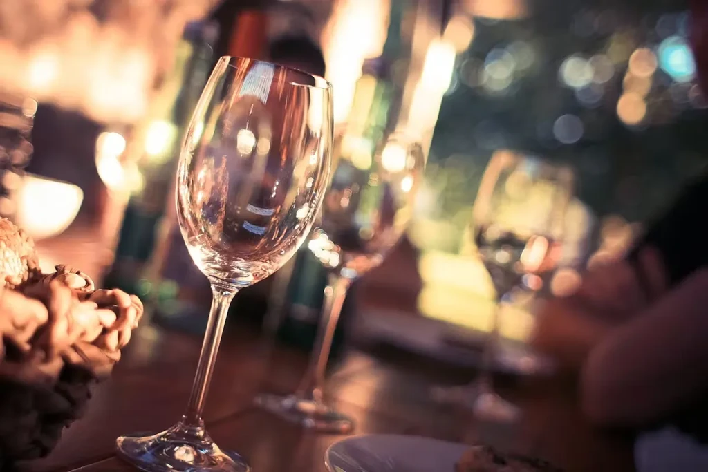 Empty wine glasses on a table with a blurred background.