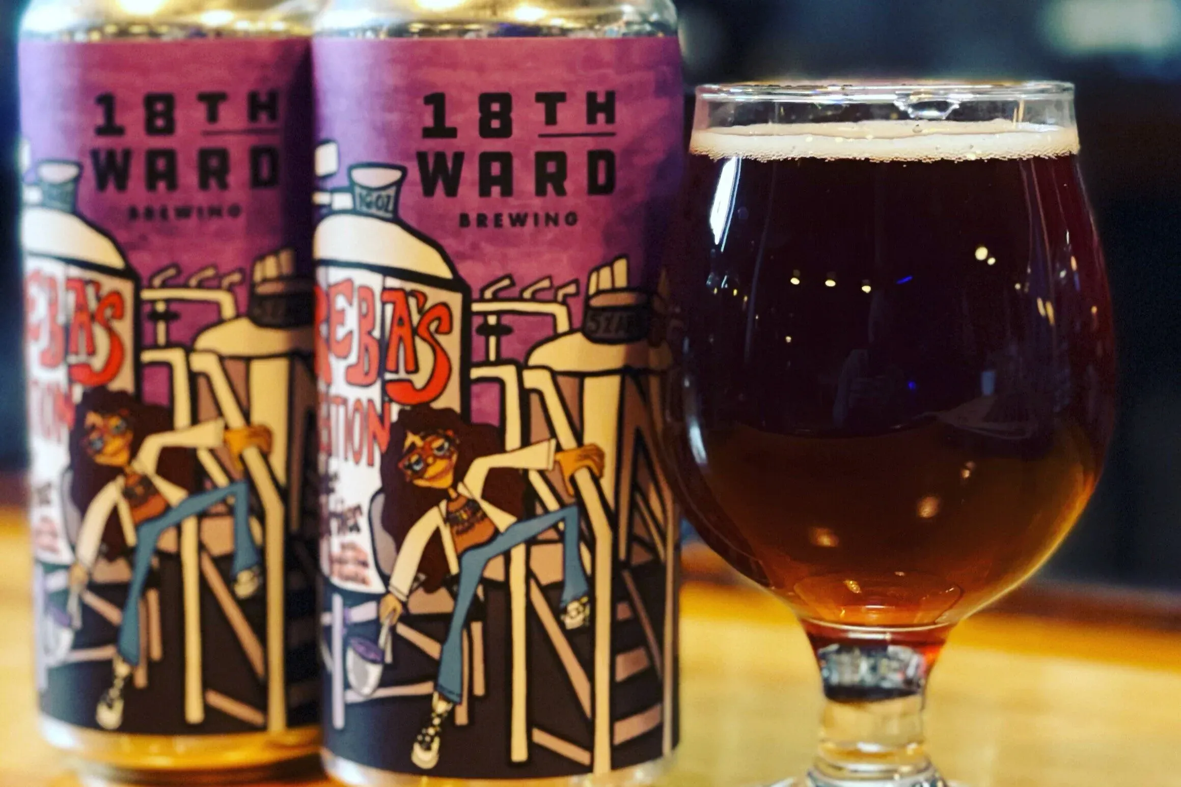 Two cans of 18th Ward Brewing beer and a glass of beer.