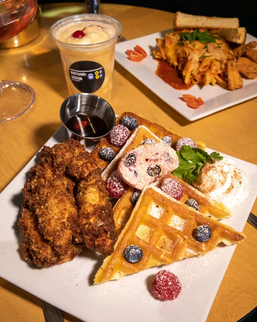 Chicken and waffles with berries, pasta, and a smoothie.