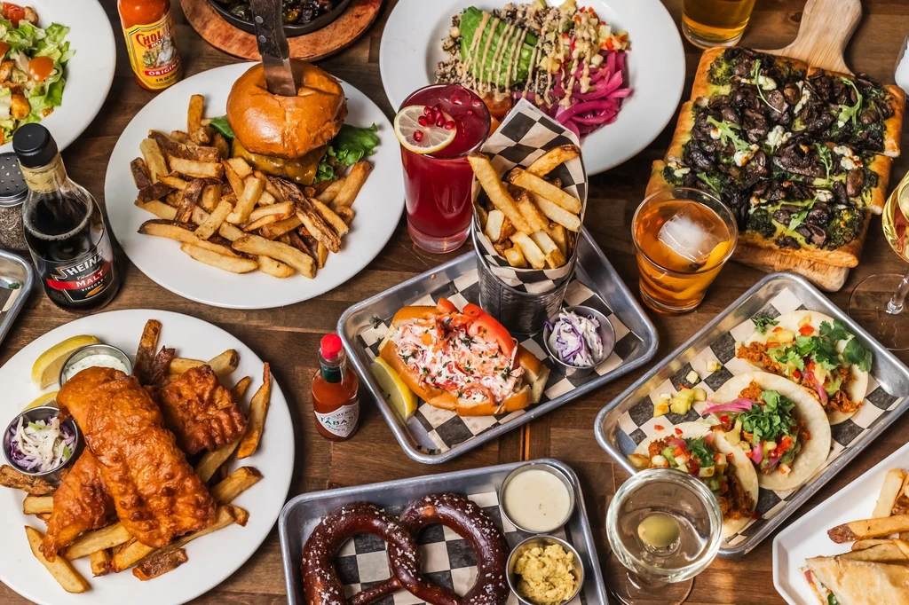 An overhead shot of a table with plates of various pub foods.