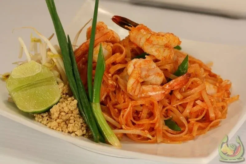 Pad Thai with shrimp, lime, scallions, and crushed peanuts.