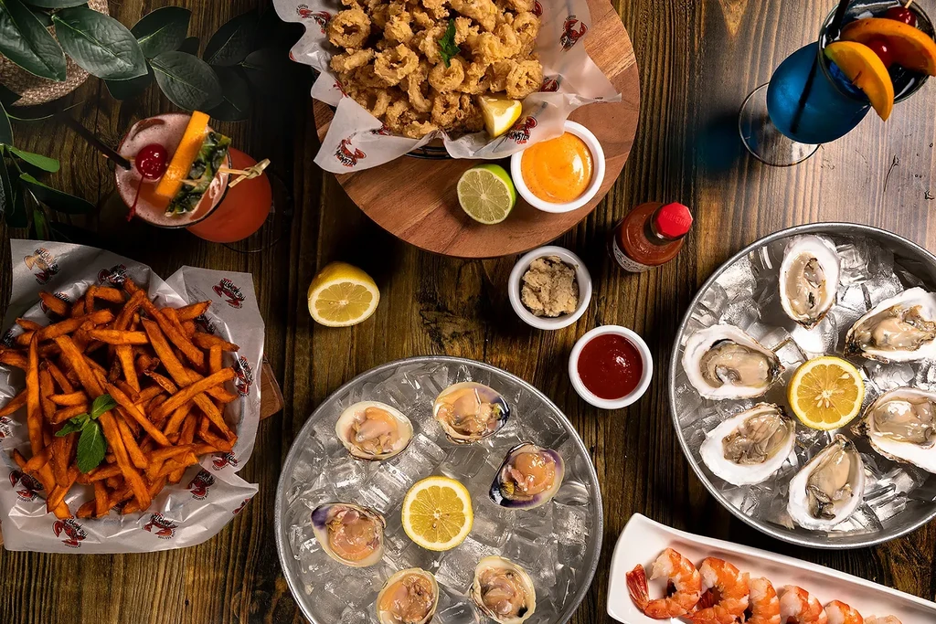 Top-down view of a seafood spread on a wooden table.