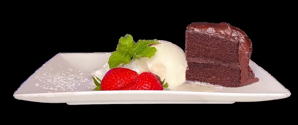 Chocolate cake slice with ice cream, strawberries, and mint on a white plate.