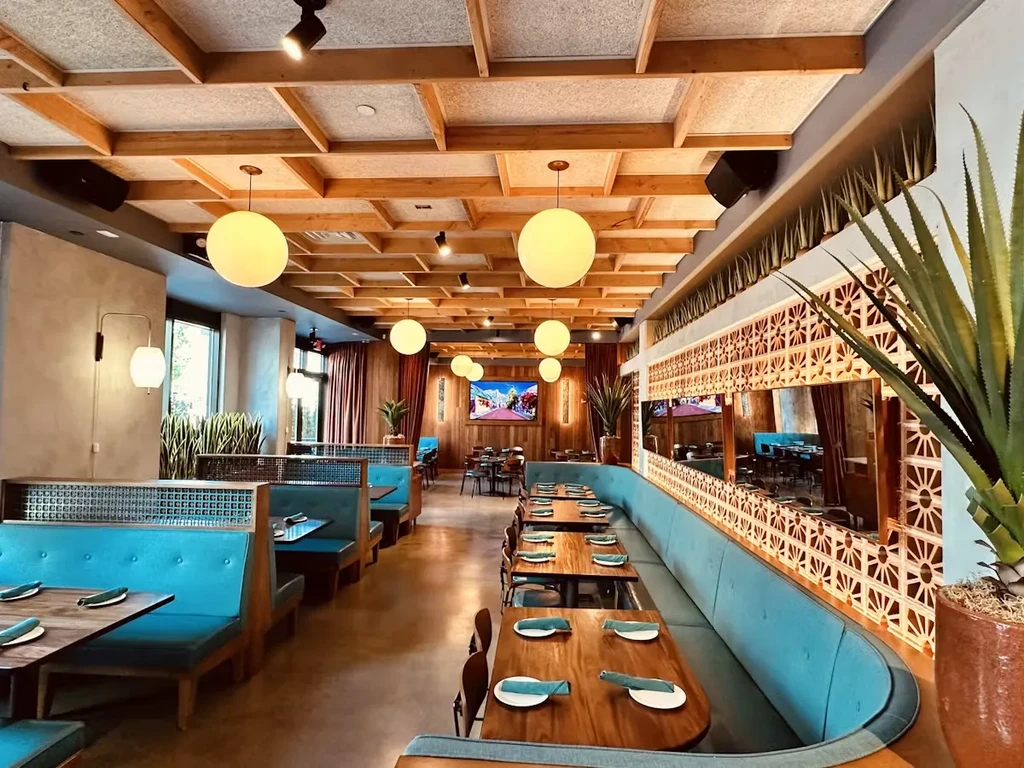 Interior of a modern restaurant with booths and tables.
