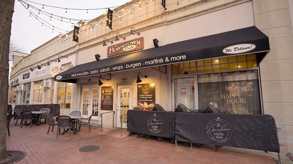 Exterior of "The Downtown Cafe" with an awning and outdoor seating area.