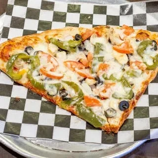 One slice of pizza with olives, bell peppers, tomatoes, and mushrooms.