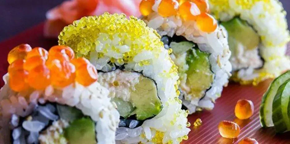 Sushi rolls with avocado, crab meat, and flying fish roe.