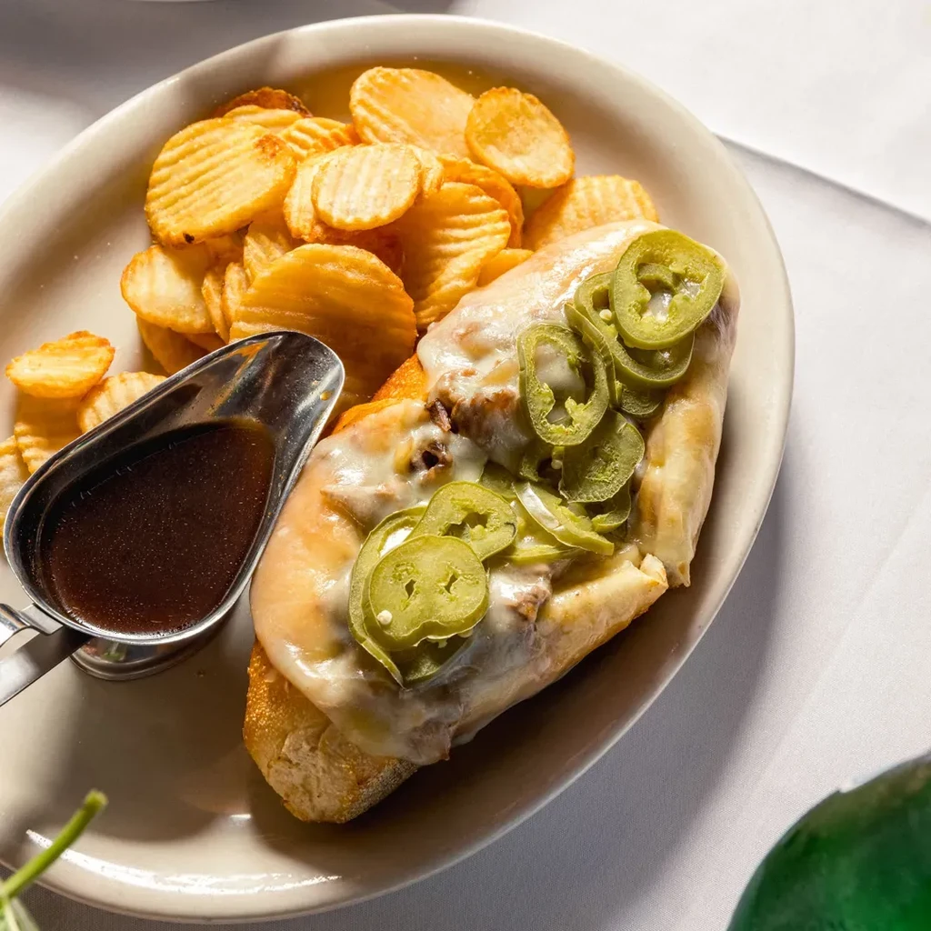 Philly cheesesteak with jalapeños, gravy, and ridged potato chips.