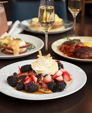 Close-up of a table full of brunch foods, including French toast.