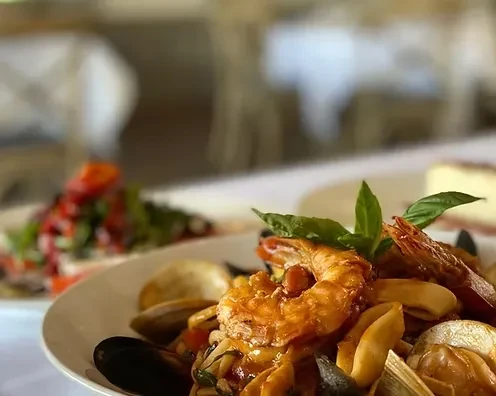 A close-up of a seafood dish with shrimp, mussels, and clams.