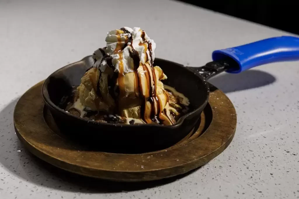 Skillet cookie with ice cream, whipped cream, and caramel.