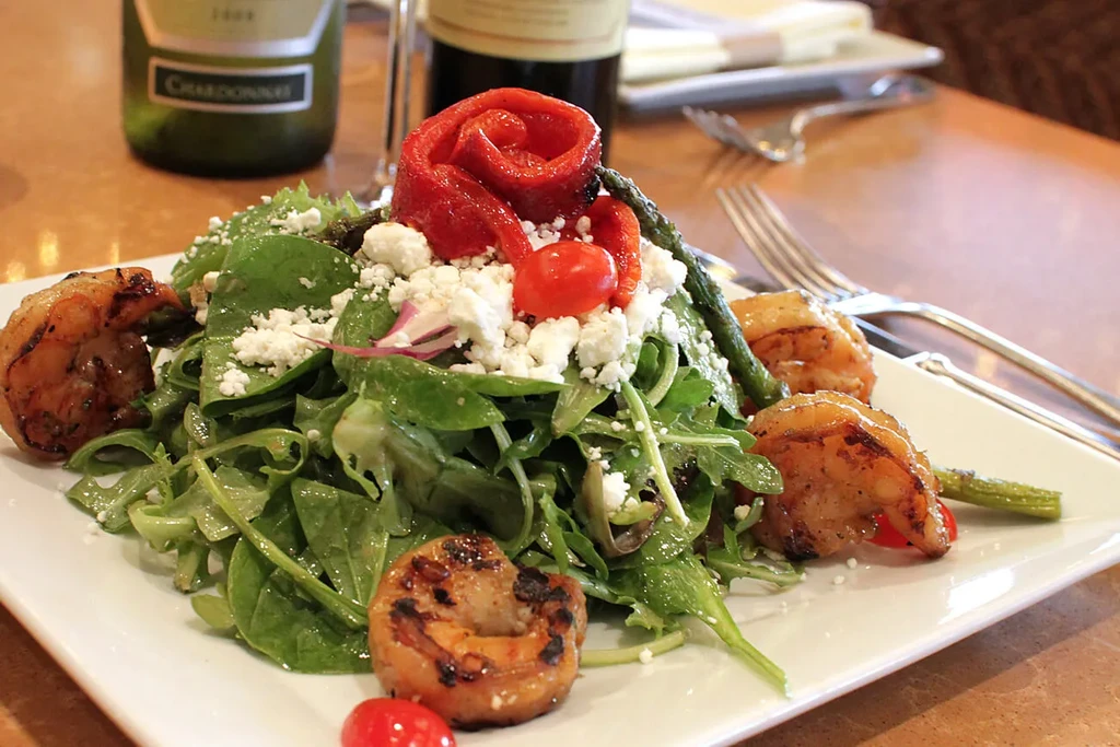 Grilled shrimp and salad with feta cheese, asparagus, tomatoes, and peppers.