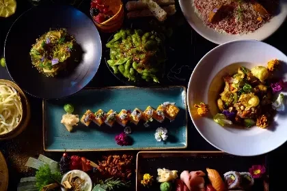 An overhead view of various beautifully arranged Japanese and Asian dishes.