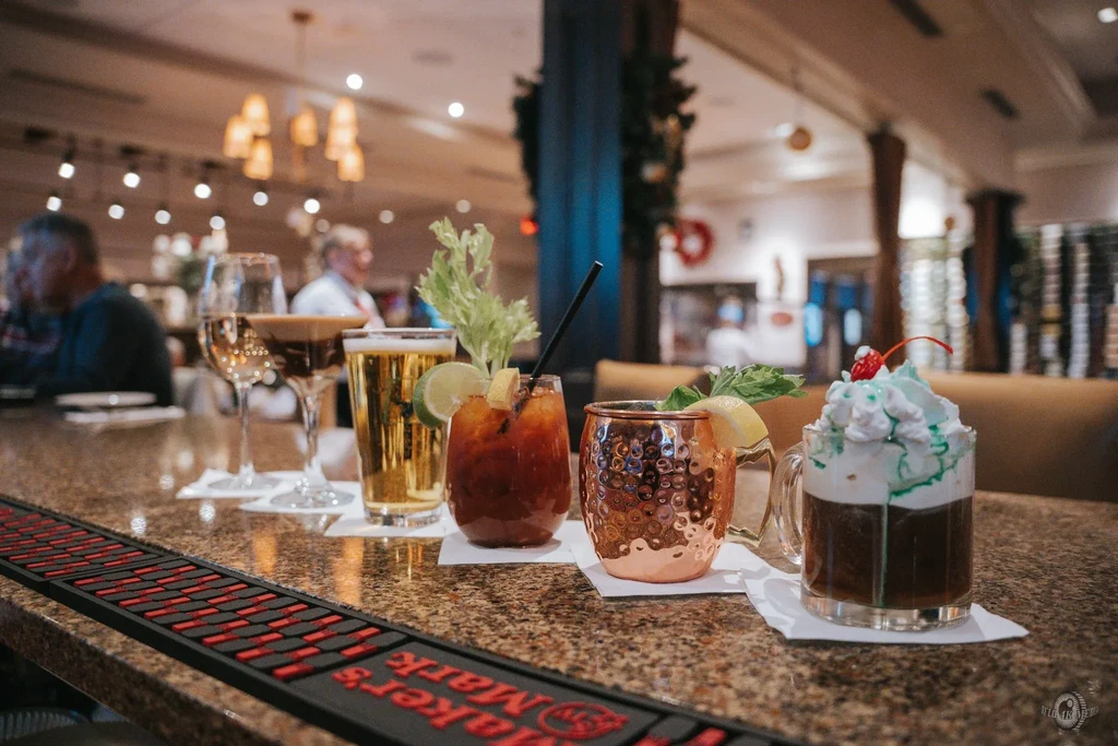 A variety of cocktails on a bar counter at a restaurant.