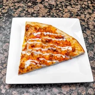 A slice of buffalo chicken pizza with ranch drizzle on a white plate.