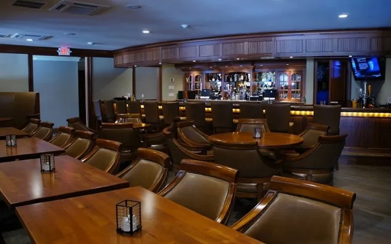 Sophisticated, empty restaurant bar interior with warm wooden decor.