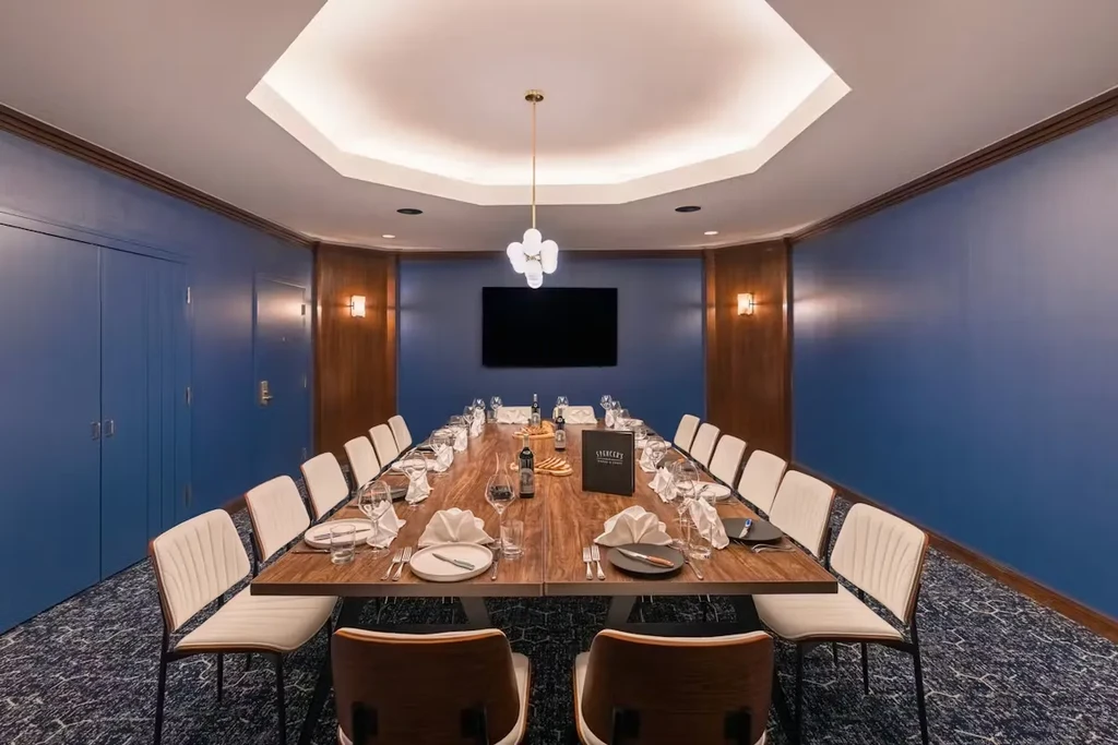 Formal private dining room with blue walls and long wooden table.