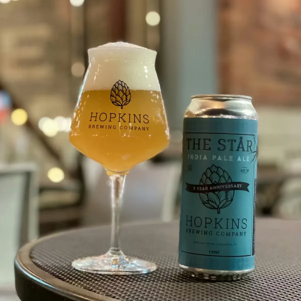 Hopkins Brewing glass of beer and teal "The Star" IPA can.