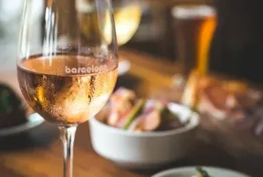 Close-up of a frosted rosé wine glass labeled 'barcelona'.