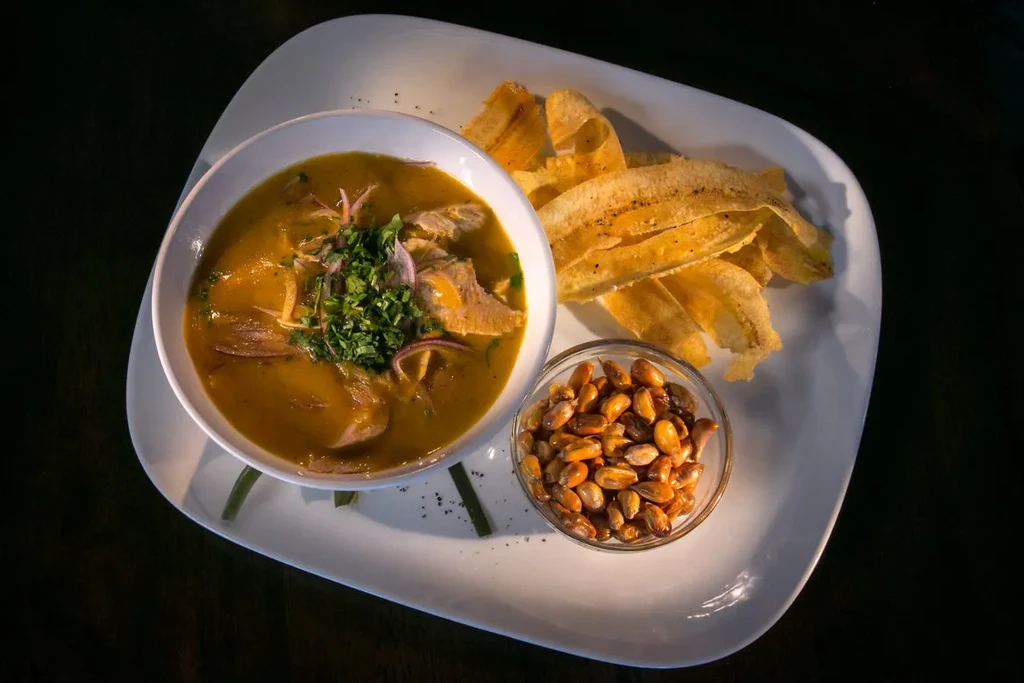 Fish soup with plantain chips and toasted corn kernels.