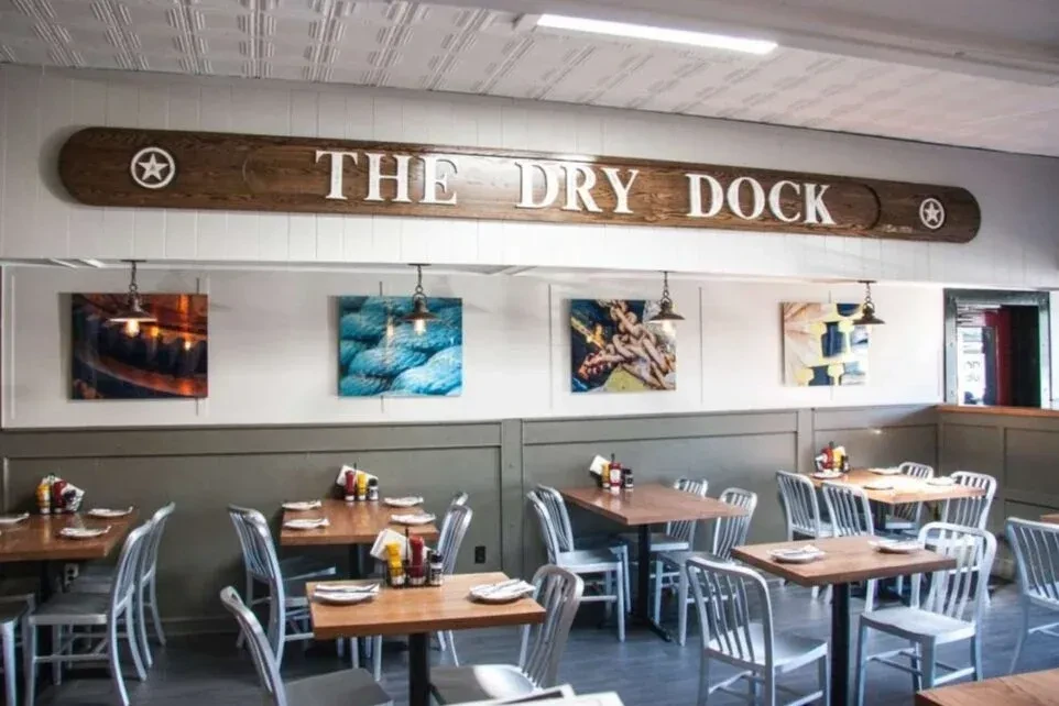 The Dry Dock restaurant with empty tables and nautical-themed decor.
