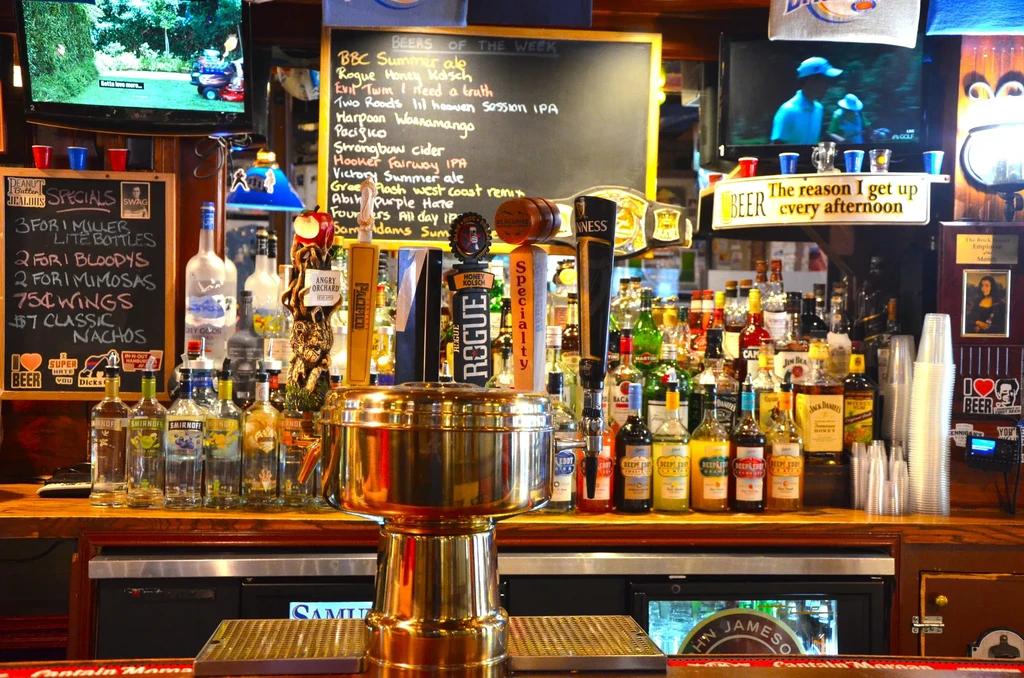 A well-stocked bar with tap handles and bottles of liquor.