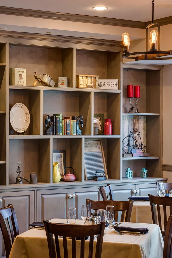 Built-in shelving unit with vintage decor in rustic restaurant setting.
