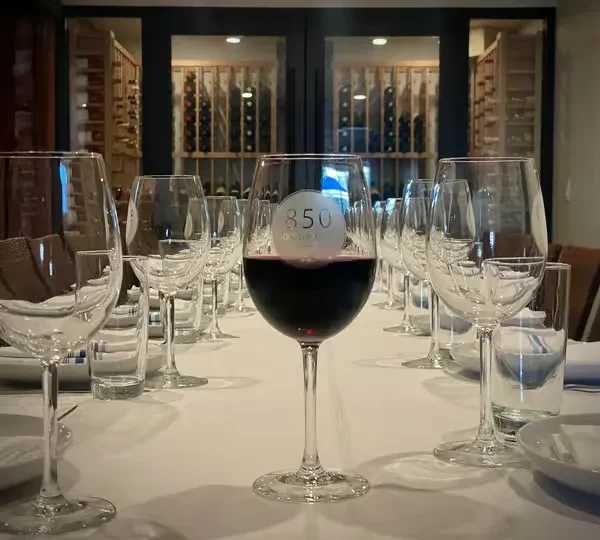Table set for wine service, featuring '850' glass and wine cellar.