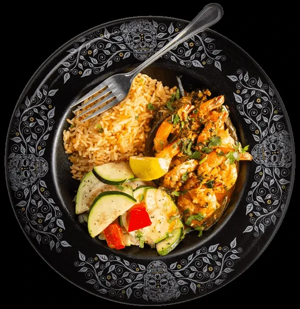 Shrimp, Spanish rice, zucchini, lemon on a sugar skull plate.