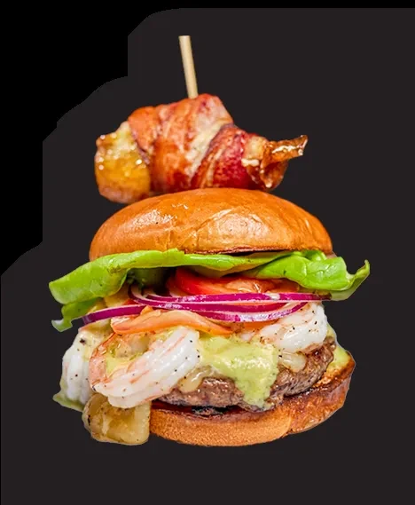 Gourmet burger with shrimp, green sauce, and skewer-secured crispy component.