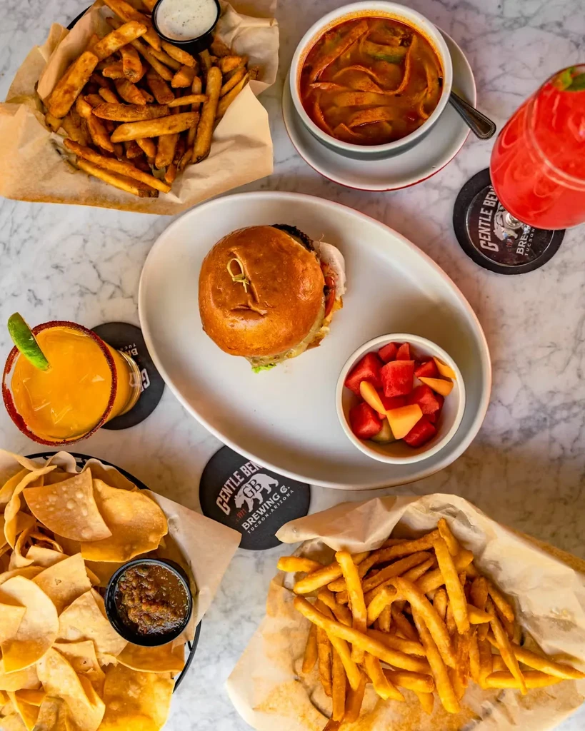 Overhead: table laden with fries, burger, soup, chips, and drinks.