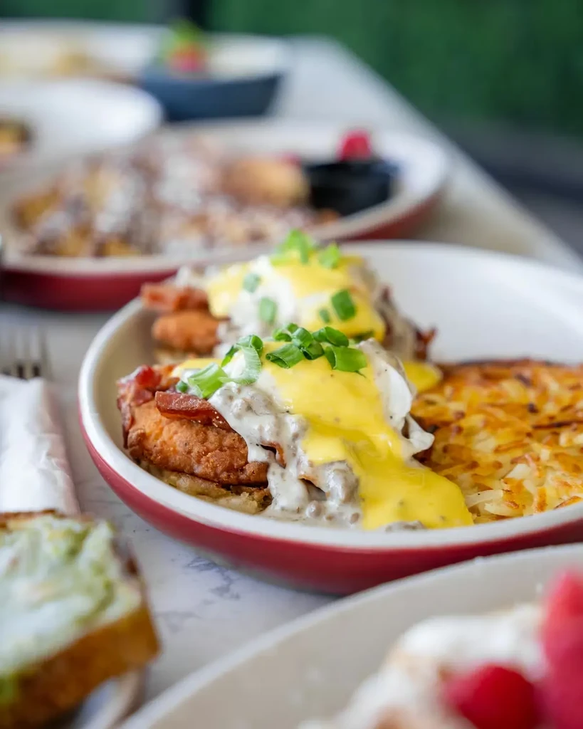 Fried chicken Eggs Benedict, gravy, poached egg, hollandaise, hash browns.