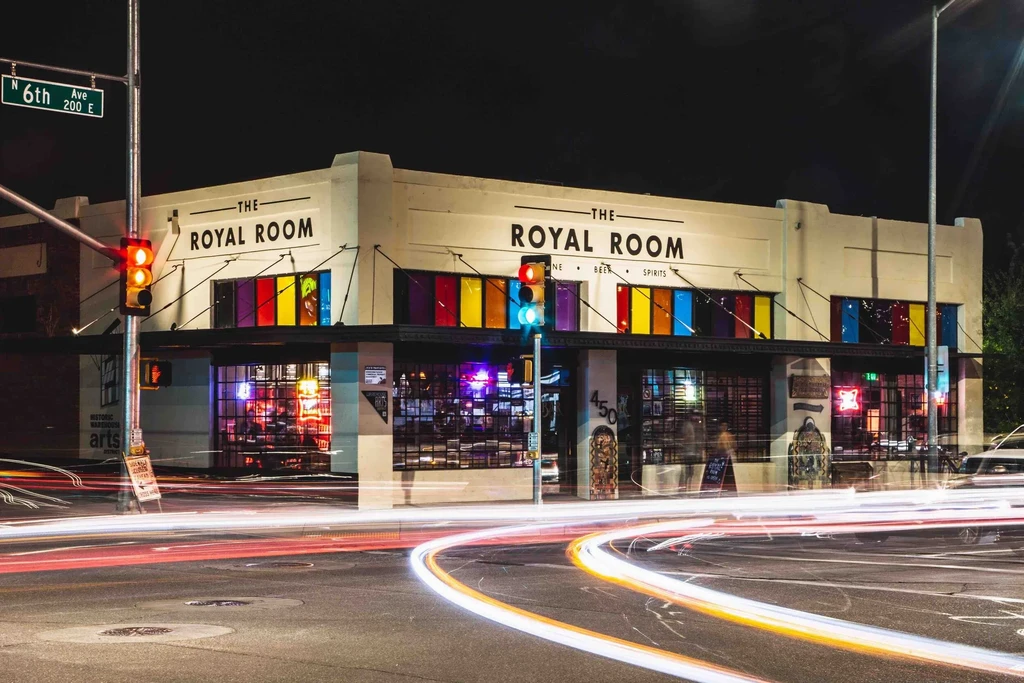Long exposure night photo of 'THE ROYAL ROOM' bar with light trails.