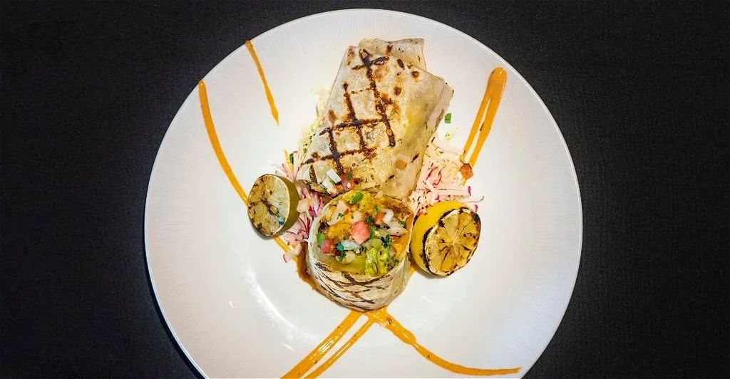 Grilled wrap halves, colorful vegetable filling, slaw, grilled citrus.