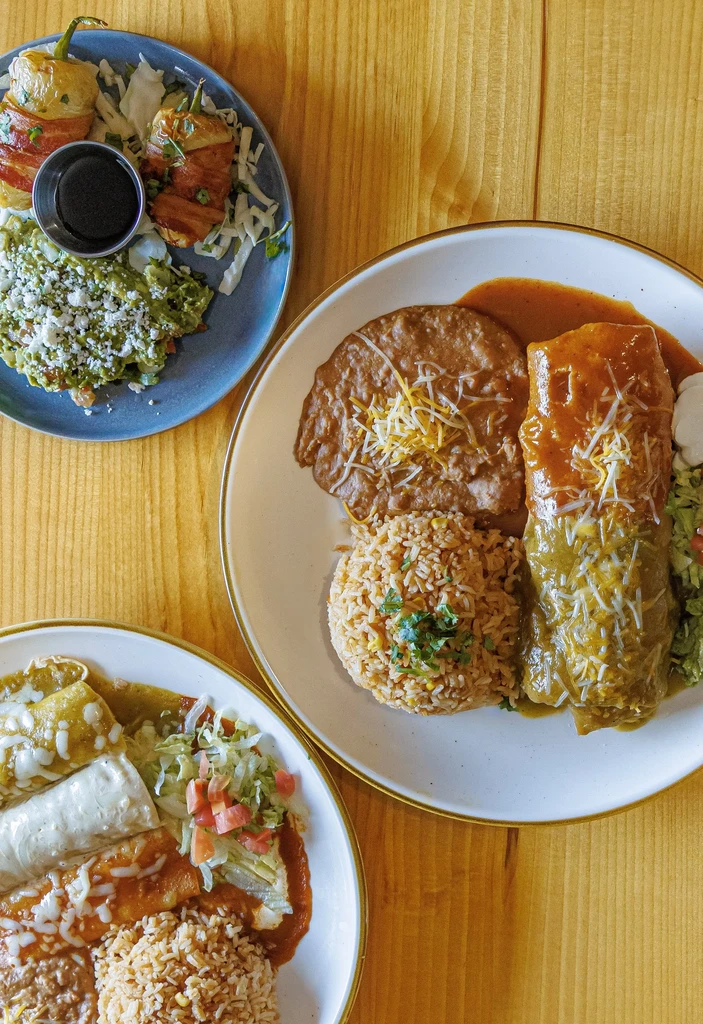 Top-down view of multiple Mexican and Tex-Mex dishes.