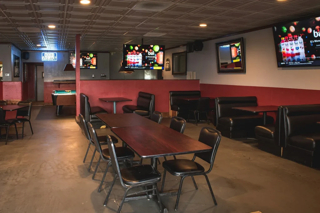 Interior of a rustic casual restaurant, showing seating and layout.
