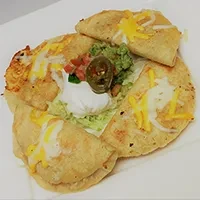 Golden quesadillas with melted cheese, guacamole, sour cream, and a jalapeño.
