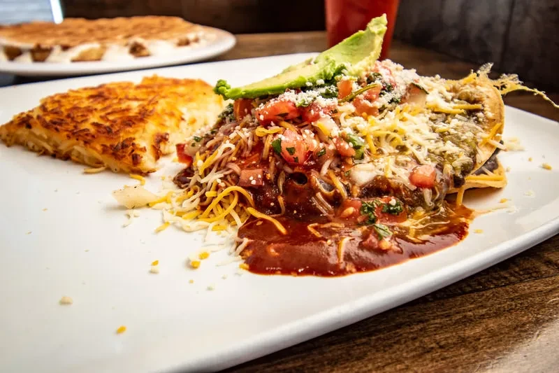 Close-up of a Mexican breakfast with hash brown and avocado.