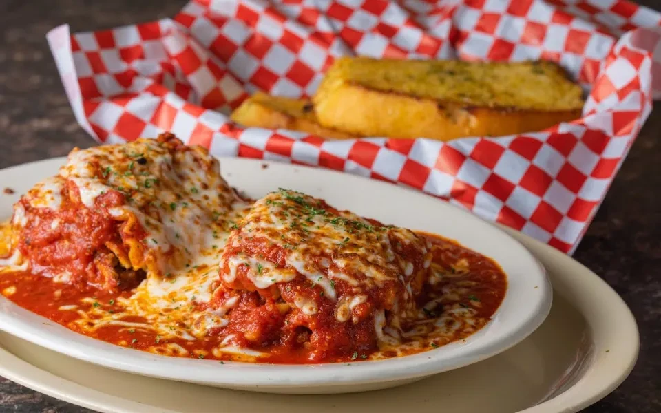 Baked pasta with marinara, melted mozzarella, herbs, and garlic bread.