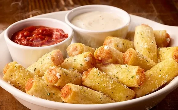 Parmesan-herb cheese sticks with red marinara and creamy white dips.