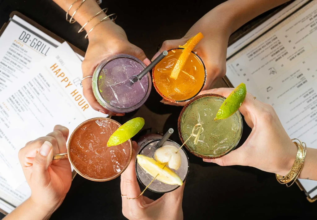 Overhead view of five distinct cocktails held in a circular formation.