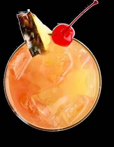 Orange-yellow cocktail with ice, pineapple, and cherry, viewed from above.